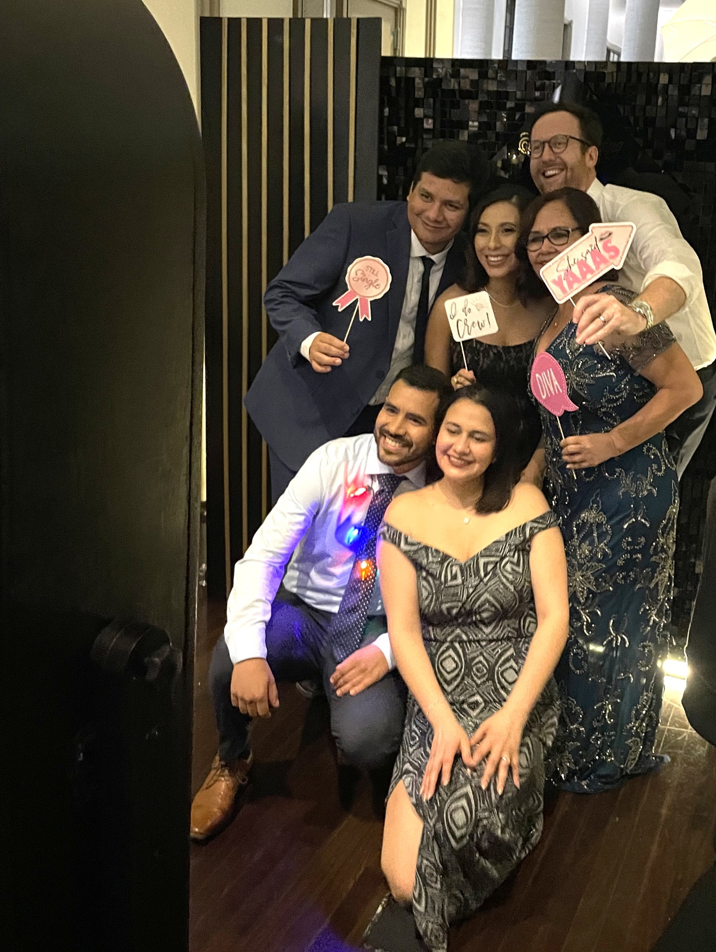 Guests posing with props in the photo booth