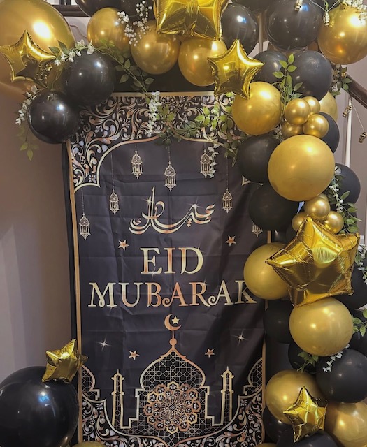 Eid Mubarak backdrop with black and gold balloon garland and star foils