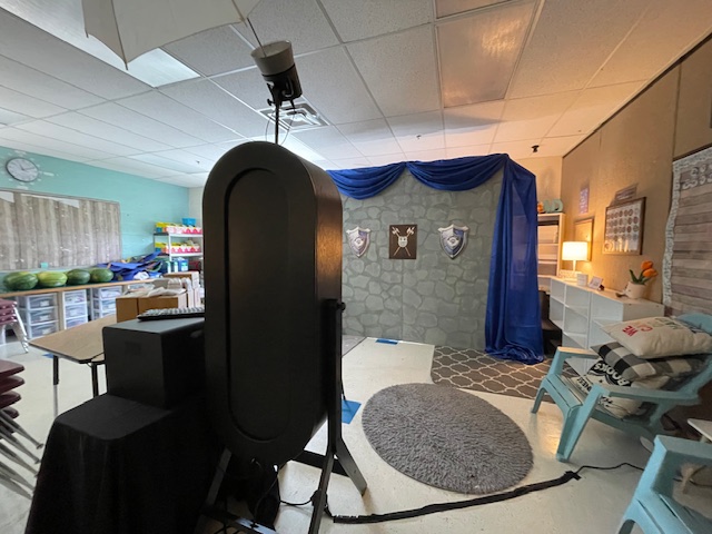 Photo booth setup with blue draped backdrop