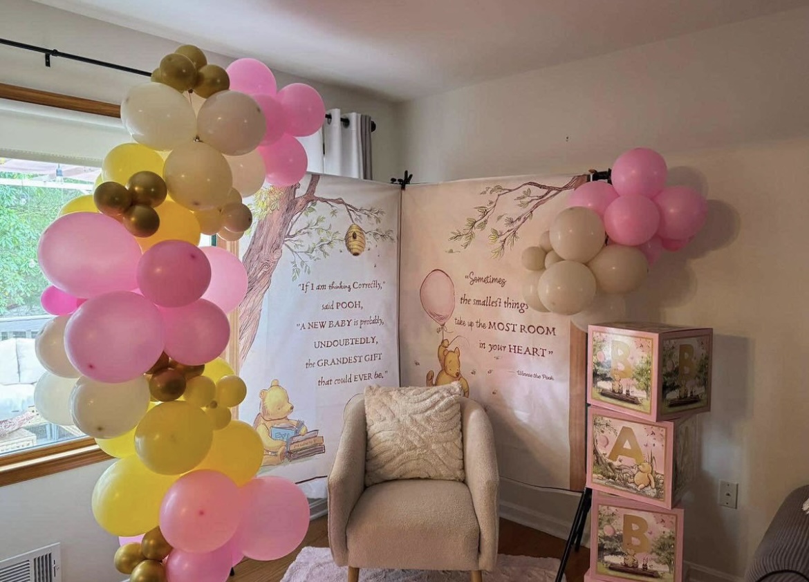 Classic Winnie the Pooh baby shower with pink and gold balloon garland
