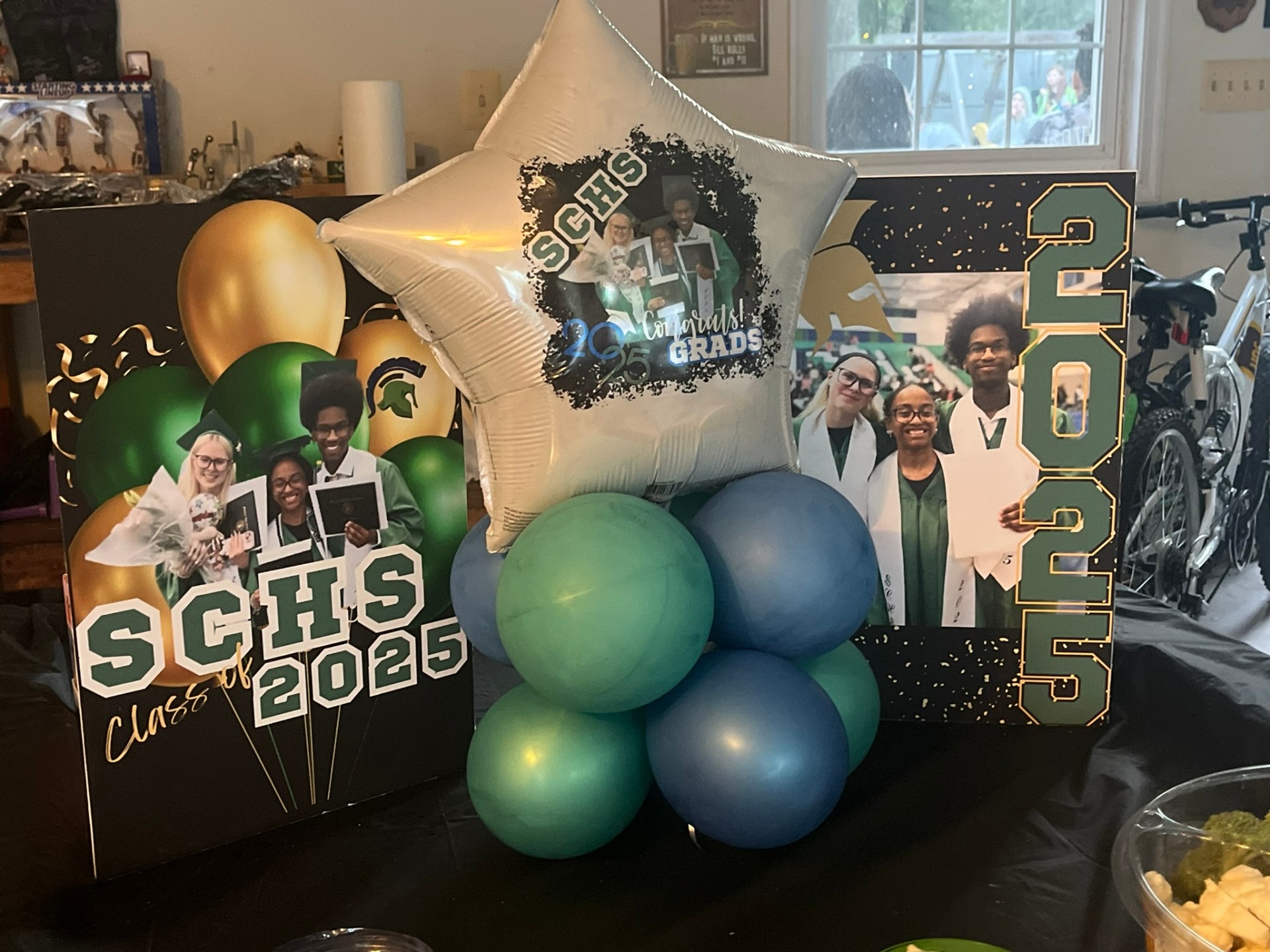 SCHS Class of 2025 graduation centerpiece with balloons and photo boards